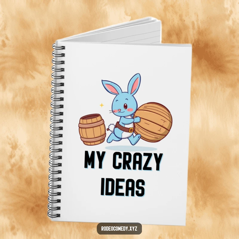 Funny blue bunny wearing spurs, chasing a rolling barrel, on the cover of a lined notebook for jotting down playful ideas.
