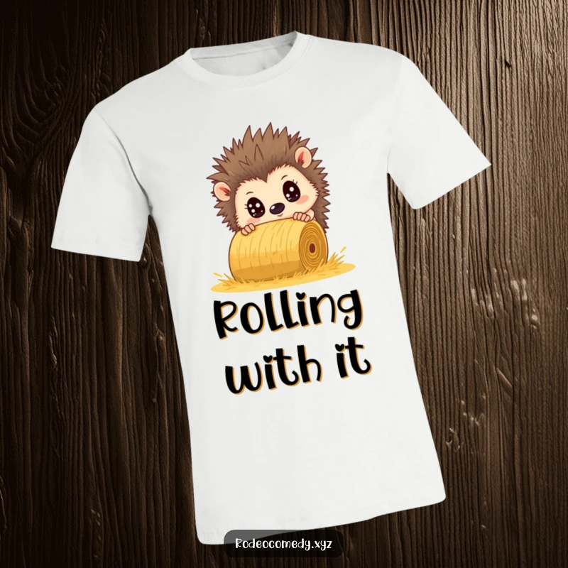Funny hedgehog T-shirt, comically wide-eyed, narrowly escaping a rolling hay bale. A picture of frantic humor.